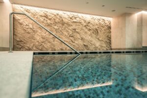 Rock imitation made of durable gunite in a hotel pool environment