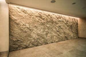 Artificial rock made of sprayed concrete with a realistic texture in an indoor pool area